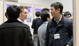 Researchers interacting at the symposium’s poster session.
