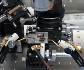 A photograph showing the experimental setup employed in the study. Electrodes made from the same material inject electrons and holes into an organic semiconductor.