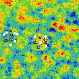 This scanning transmission electron micrograph shows the two distinct regions in metallic glass: high-density regions (red areas) and low-density regions (blue areas). The crystal structures of the two regions have been superimposed.